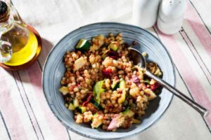regola con verdure in una ciotola e accanto una bottiglia di olio